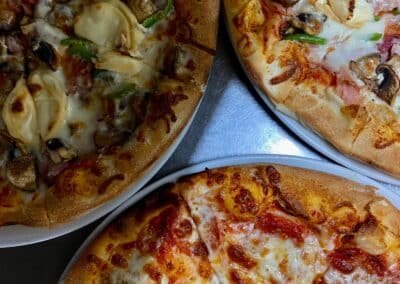 three delicious pizzas