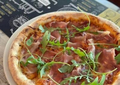 pizza with green herb and prosciutto